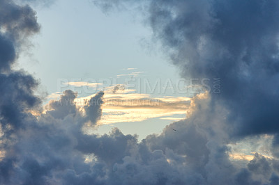 Buy stock photo Copy space with dark clouds on a sunny day with a bright blue sky. Quiet landscape and peaceful cloudscape wallpaper with sunshine in nature. Beautiful scenery of heaven with cloudy weather outside