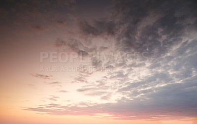 Buy stock photo Dark clouds in a sunset sky background with copy space. Cloudscape climate view of dramatic sky with signs of thunder storm on the horizon. Landscape of the sun at dusk in autumn or winter weather