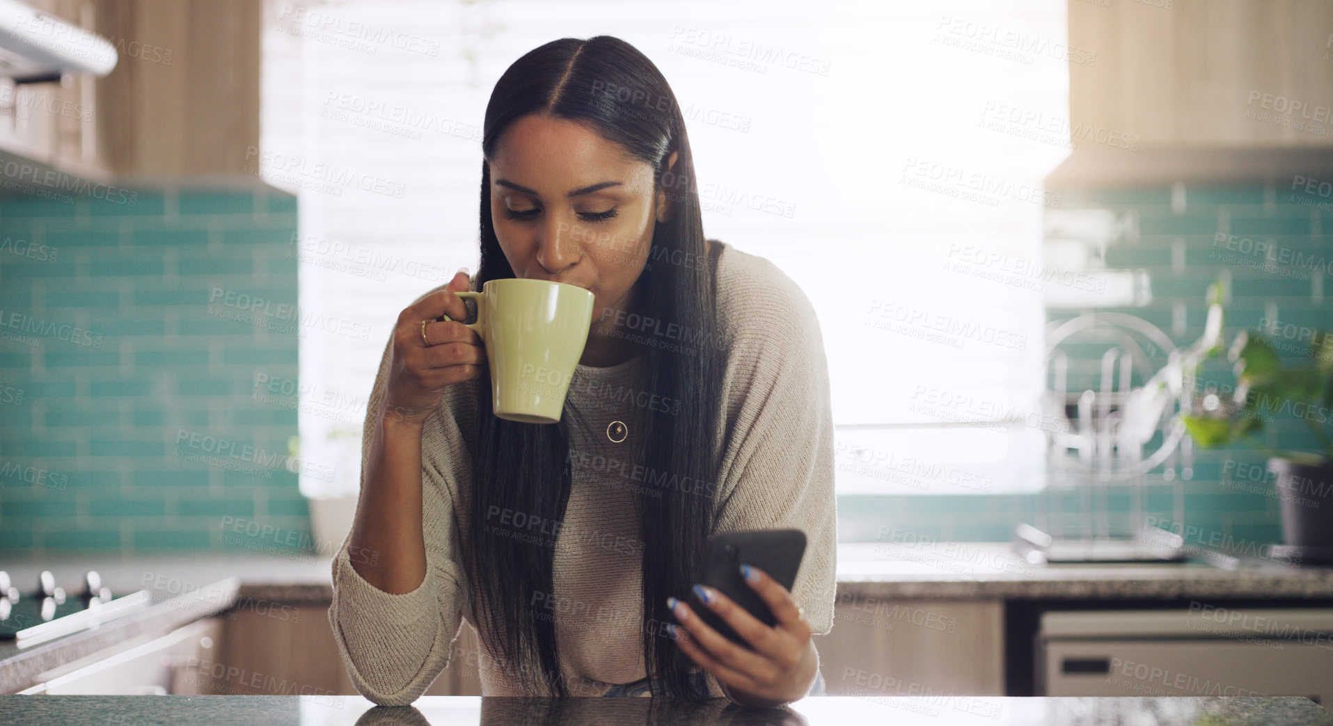 Buy stock photo Phone, texting and woman with coffee in a kitchen relax with social media, app or reading. Smartphone, streaming and female drinking tea in her home in the morning, calm and peaceful in her apartment