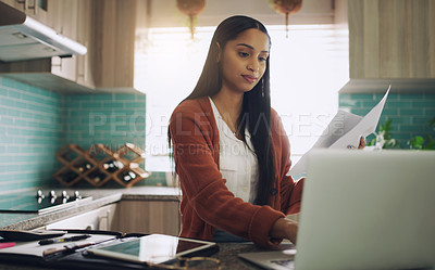 Buy stock photo Shot of a young businesswoman working from home using her laptop at home
