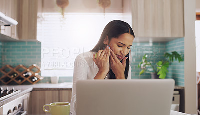 Buy stock photo Shot of a young businesswoman suffering from a tooth ache while eating an apple at home