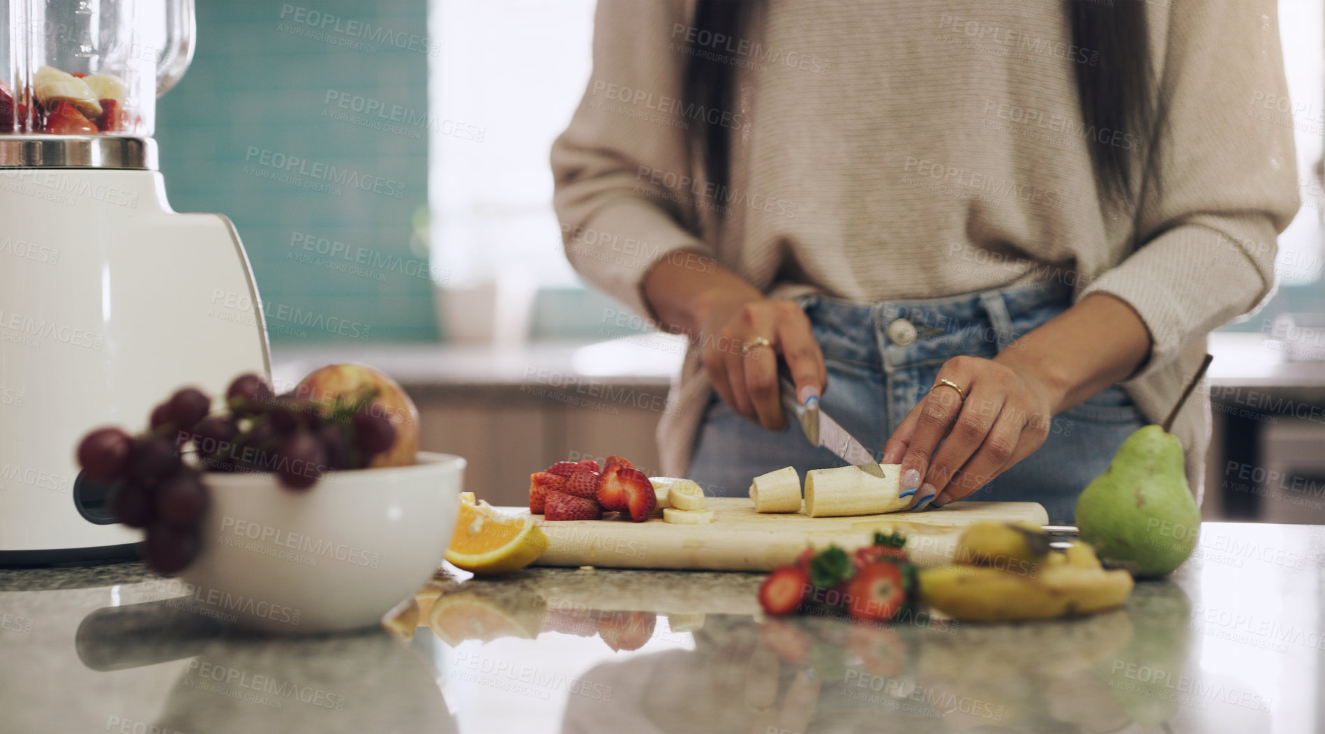 Buy stock photo Hands, fruit and woman in a kitchen for smoothie, breakfast and vegan nutrition in her home. Closeup, counter and female nutritionist with banana, apple and strawberry for healthy lifestyle shake