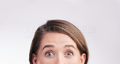 Buy stock photo Studio portrait of a young woman looking surprised against a grey background