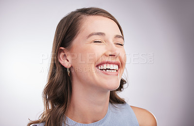Buy stock photo Studio shot of a happy young woman posing against a grey background