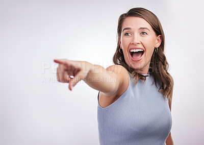 Buy stock photo Woman, excited and pointing in direction with news, announcement and surprise isolated on white background. Information, about us and wow reaction with crazy opportunity, coming soon and attention