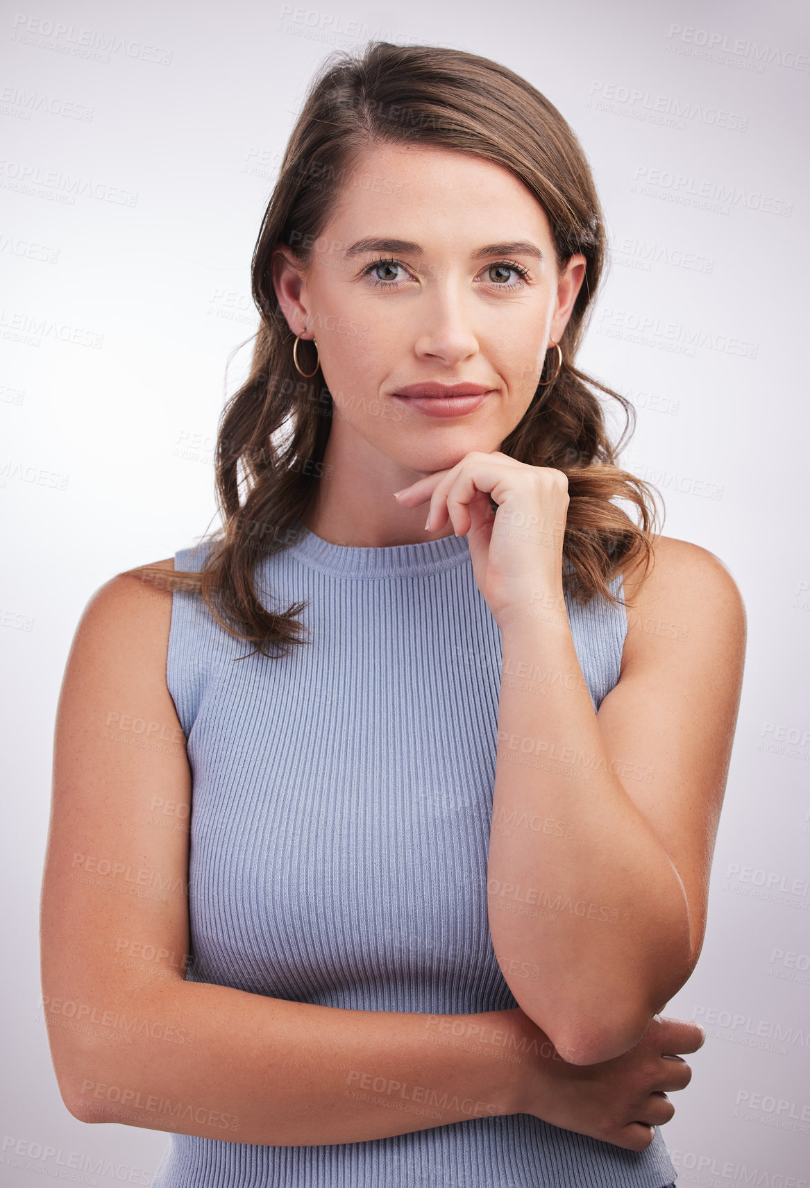 Buy stock photo Studio portrait of a confident young woman posing against a grey background