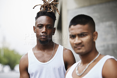 Buy stock photo Cropped portrait of two handsome young male gangsters standing outside on the street