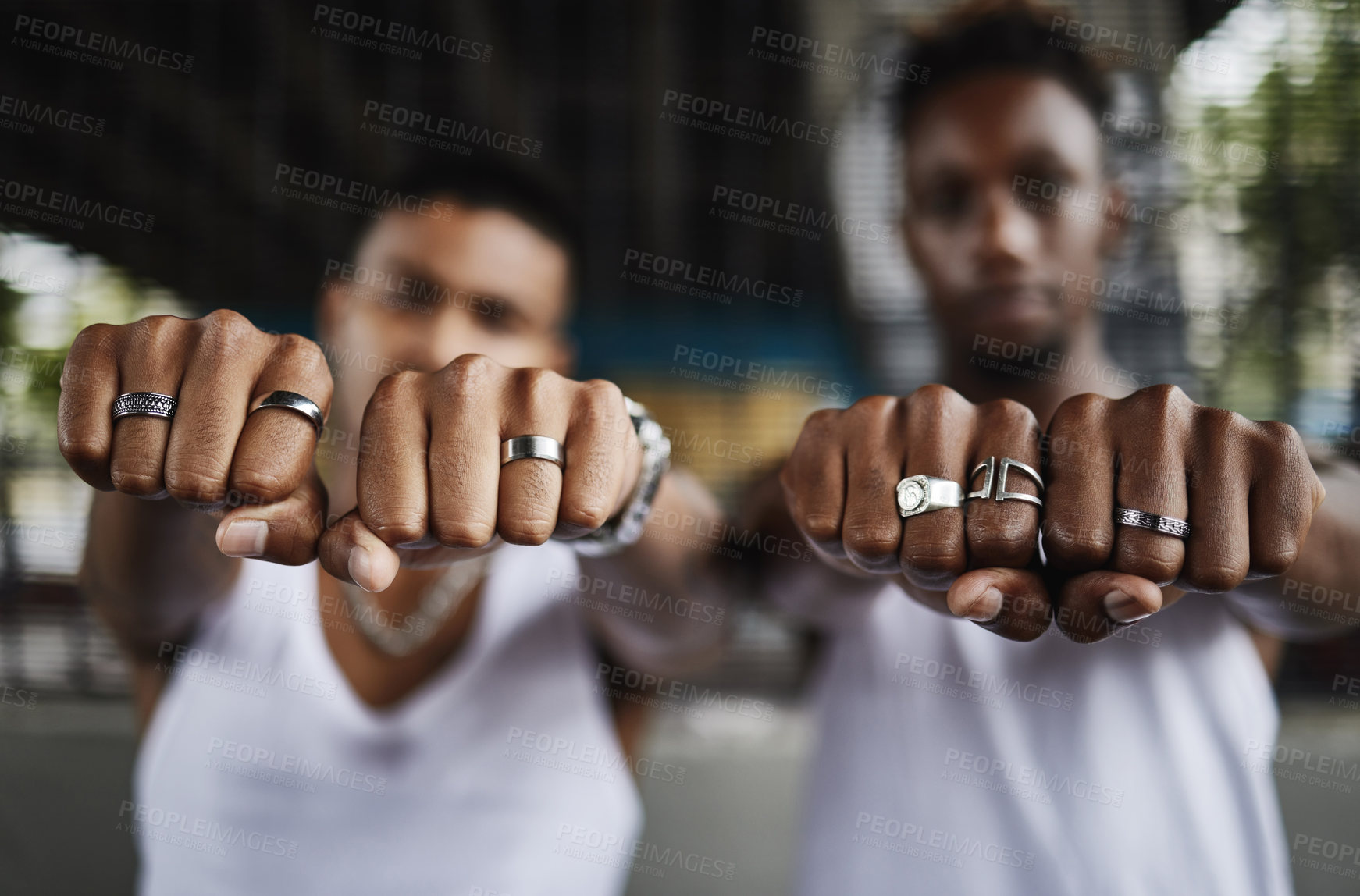 Buy stock photo Closeup shot of two male gangsters' hands showing off their rings with clenched fists