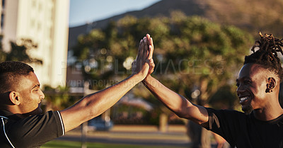 Buy stock photo Shot of two male friends working out at sunset