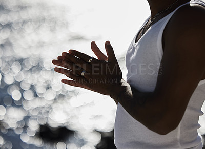 Buy stock photo Man, vest and rub with hands at beach for jewelry, hope or praying by ocean coast in nature. Closeup of male person by sea with silver rings, humble or grateful for wealth, time or outdoor fashion