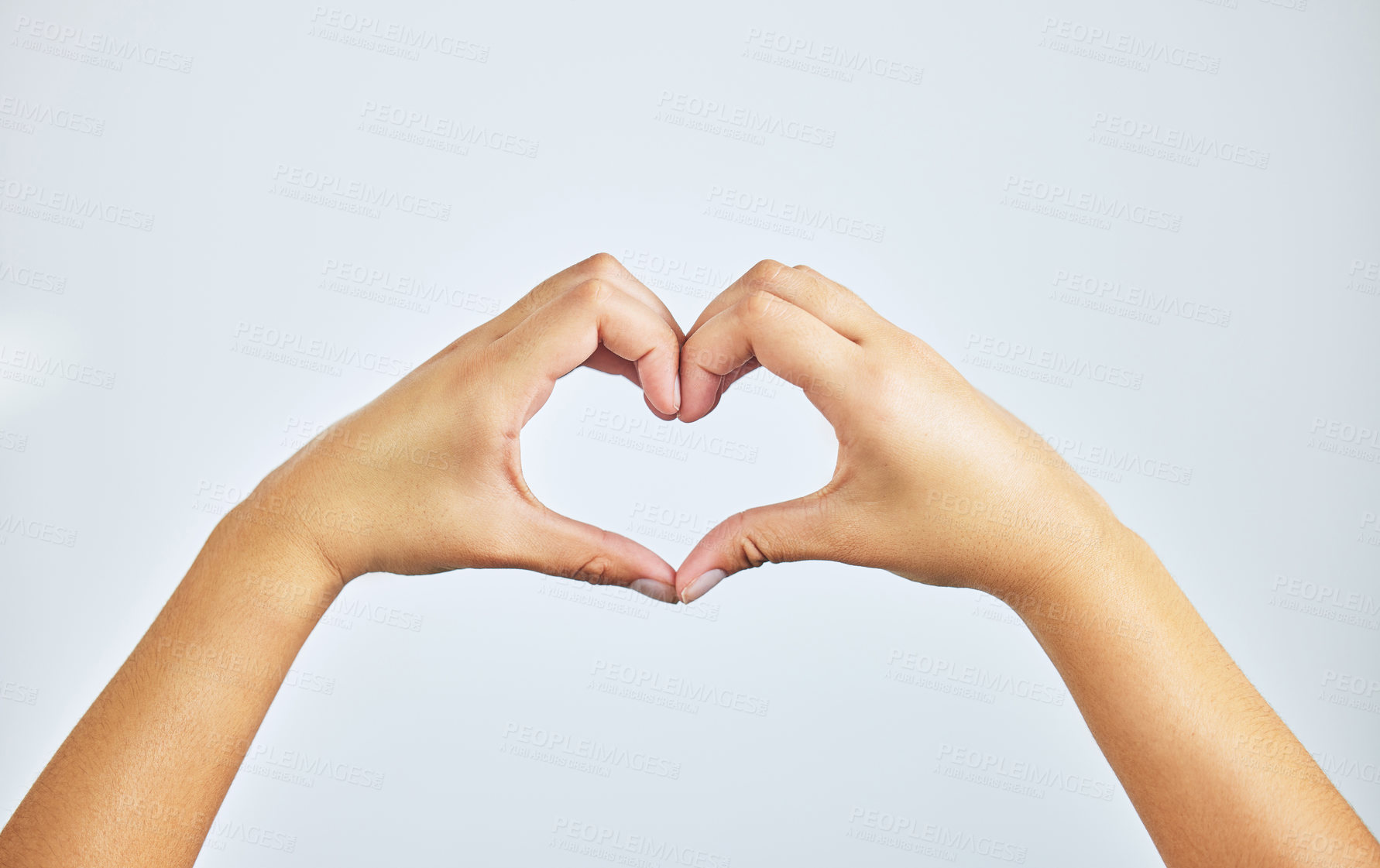 Buy stock photo Hands, closeup and person in studio with heart sign, gesture or symbol isolated on white background. Zoom, love and care icon with romance emoji for compassion, kindness and happiness for valentines