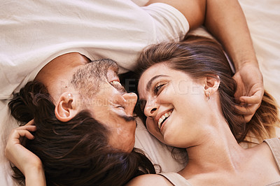 Buy stock photo Shot of a young couple having an intimate moment on the bed at home