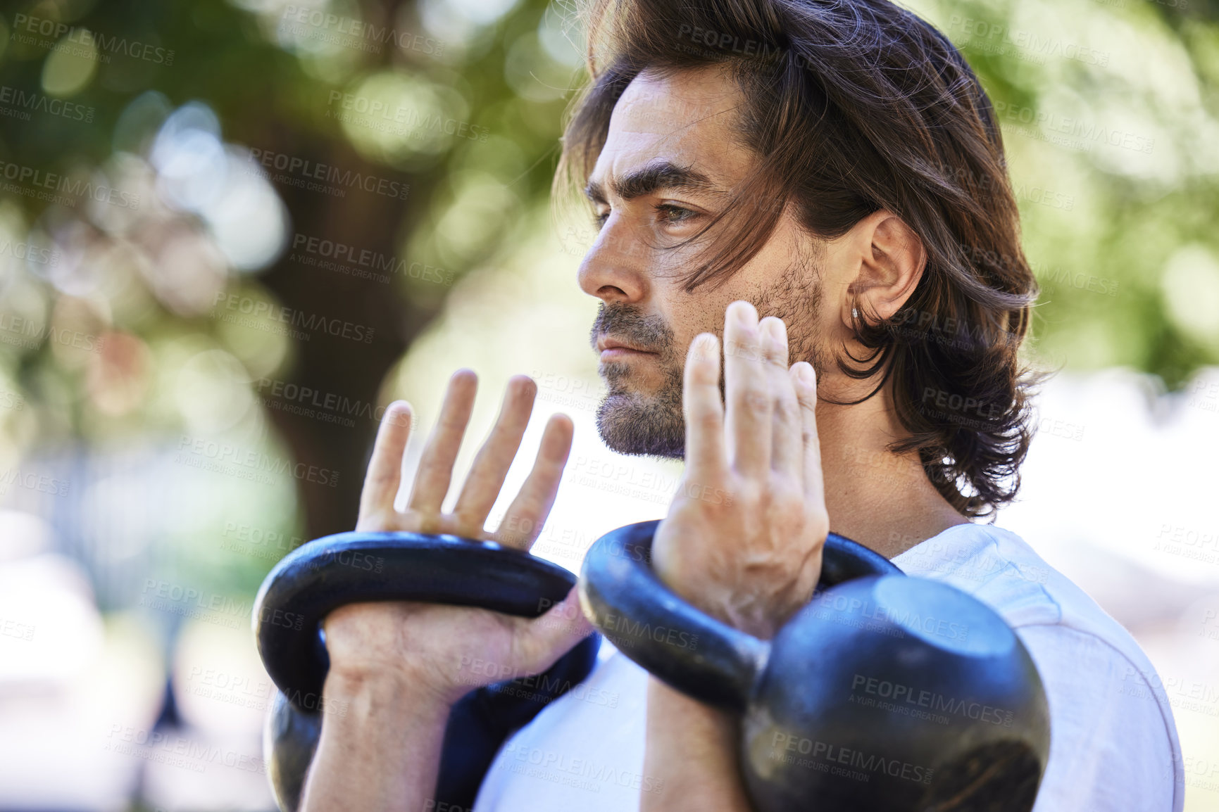 Buy stock photo Outdoor, workout and man with kettlebell in park for exercise, training and fitness in nature. Sports, male person and equipment for muscle strength, physical and wellness with weight lifting