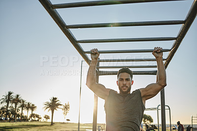 Buy stock photo Portrait of a muscular young man exercising at a calisthenics park