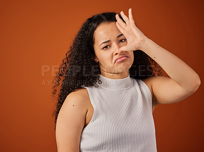 Buy stock photo Cropped portrait of an attractive young woman gesturing that something stinks in studio against a red background