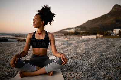 Buy stock photo Full length shot of an attractive young woman practicing yoga on the beach at sunset