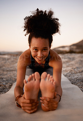 Buy stock photo Full length portrait of an attractive young woman practicing yoga on the beach at sunset