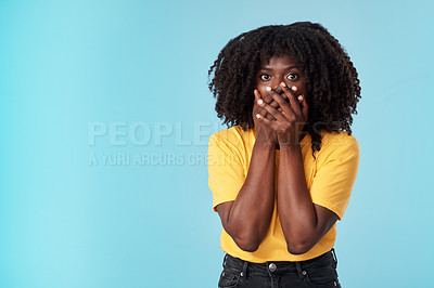 Buy stock photo Studio shot of an attractive young woman looking shocked against a blue background
