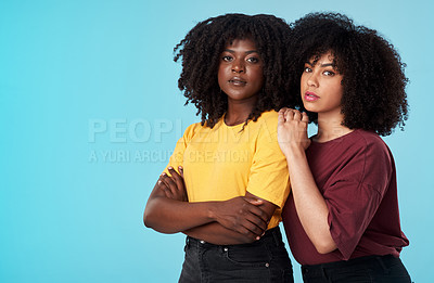 Buy stock photo Portrait, fashion and mockup with friends on a blue background in studio together for woman empowerment. Afro, trust and a serious young black female standing arms crossed with a confident friend