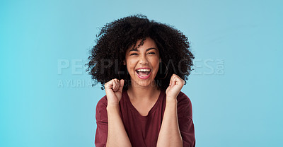 Buy stock photo Studio shot of an attractive young woman looking excited against a blue background