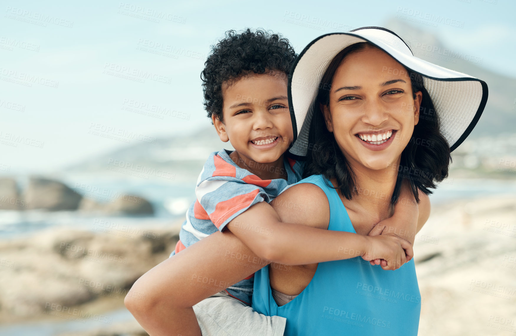 Buy stock photo Shot of a mother and son bonding while on vacation at the beach