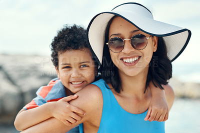 Buy stock photo Shot of a mother and son bonding while on vacation at the beach