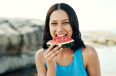 Buy stock photo Shot of a young woman eating a slice of watermelon on the beach