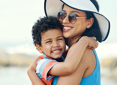 Buy stock photo Shot of a mother holding her son at the beach
