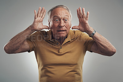 Buy stock photo Studio shot of an elderly man getting a big shock against a grey background