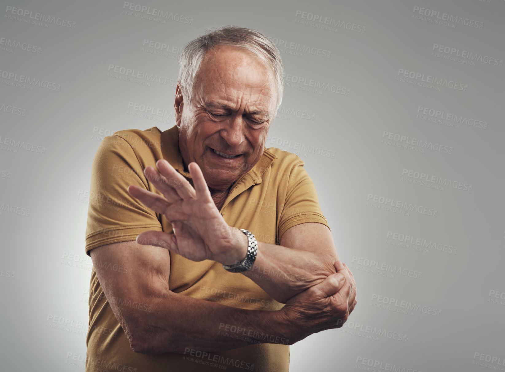 Buy stock photo Studio shot of an elderly man experiencing some pain against a grey background