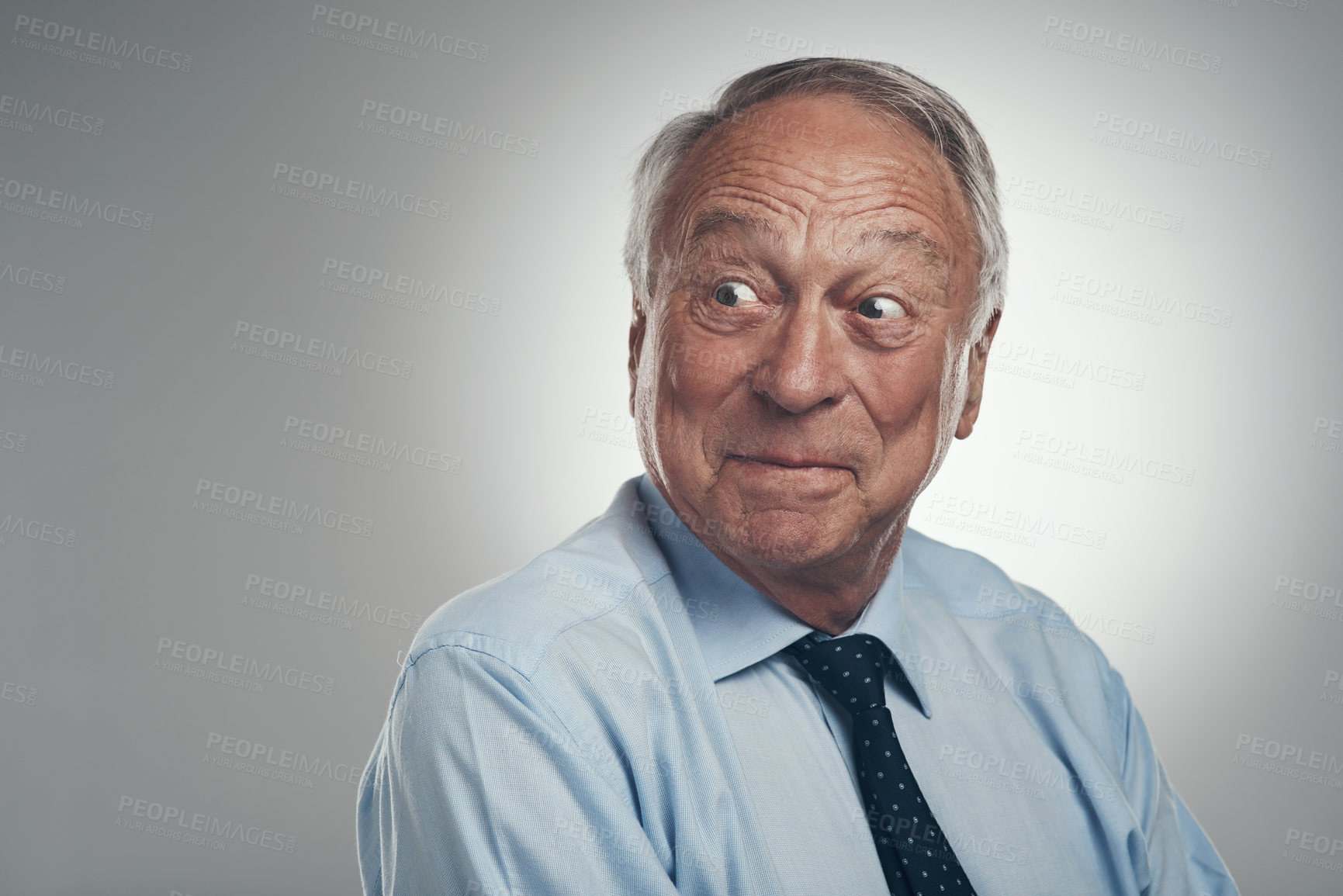 Buy stock photo Shot of a senior businessman standing alone against a grey background in the studio and looking surprised