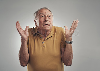 Buy stock photo Studio of an elderly man in disbelief against a grey background