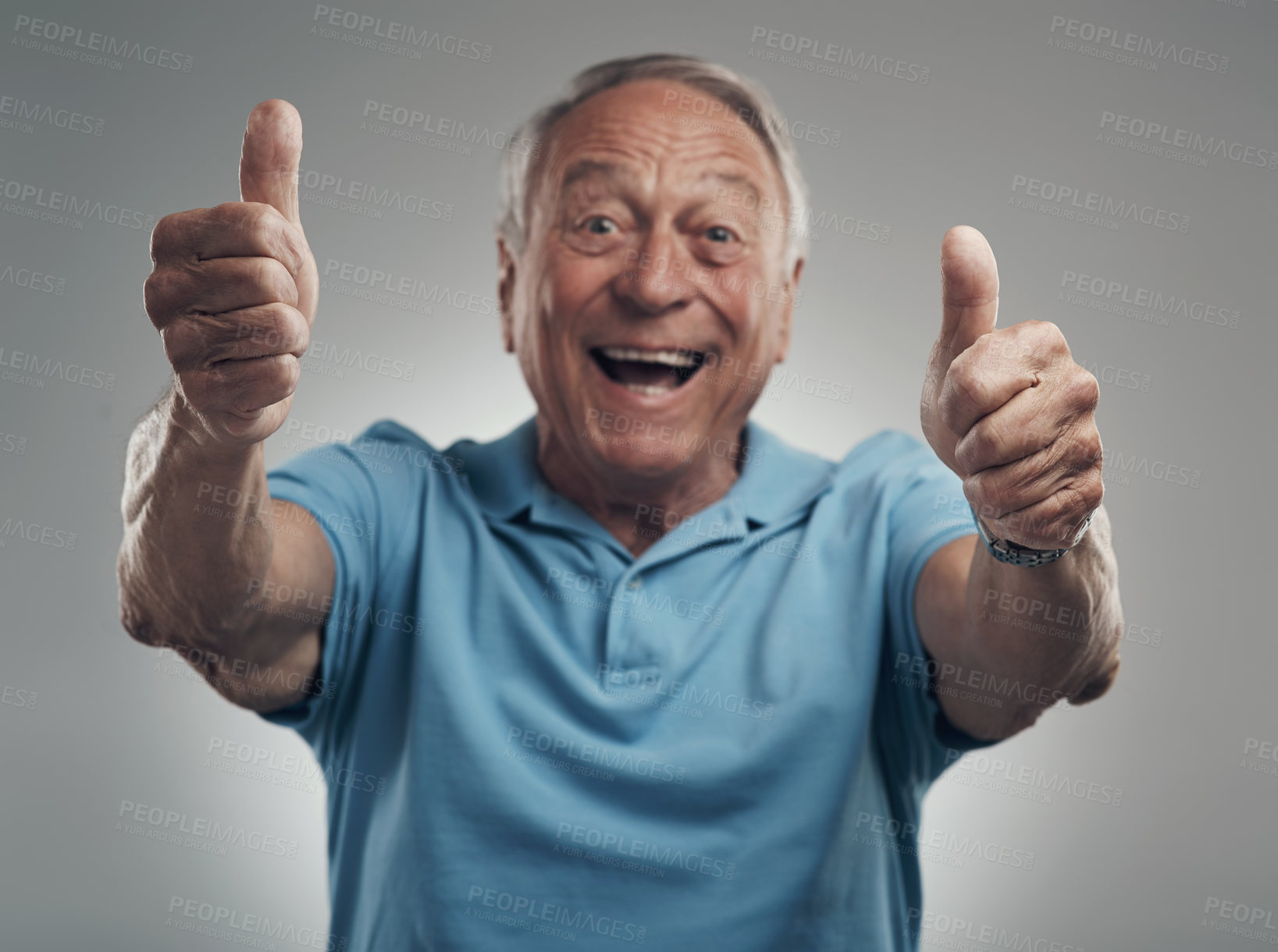 Buy stock photo Shot of a happy elderly man giving the thumbs up in a studio against a grey background