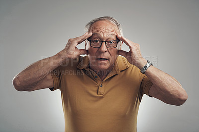 Buy stock photo Studio shot of an elderly man in disbelief against a grey background