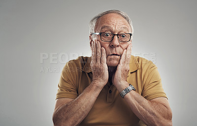 Buy stock photo Studio shot of an elderly man in disbelief against a grey background