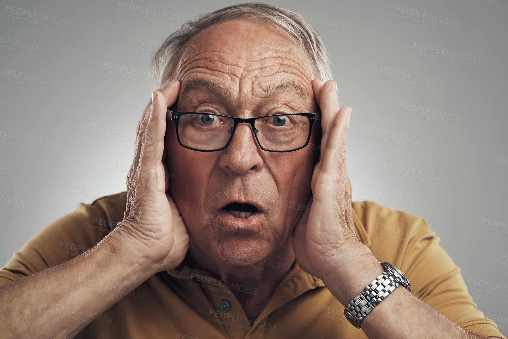 Buy stock photo Studio shot of an elderly man getting a big shock against a grey background