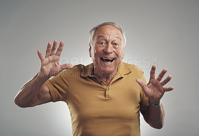 Buy stock photo Studio shot of an elderly man getting a surprise against a grey background