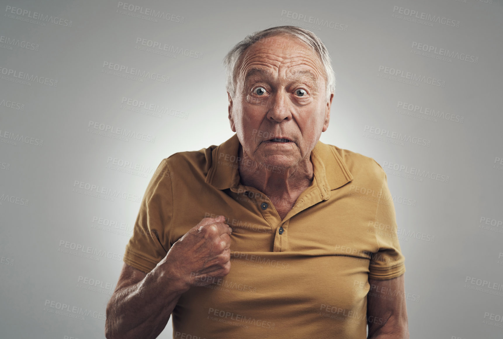 Buy stock photo Studio shot of an elderly man in disbelief against a grey background