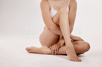 Buy stock photo Skincare, cosmetics and legs of a woman for beauty isolated on a white background in a studio. Spa, dermatology and calm model with body wellness, care and hygiene in underwear on a backdrop