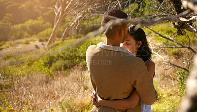 Buy stock photo Nature, love and a couple hugging or kissing outdoor while sharing an intimate moment together in summer. Field, countryside and kiss with a man and woman bonding in sweet embrace outside with mockup