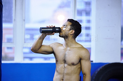 Buy stock photo Man, athlete and drinking water at gym, nutrition and hydration after workout or strength training. Male person, detox and mineral liquid for recovery after exercise, fitness and boxer or shirtless