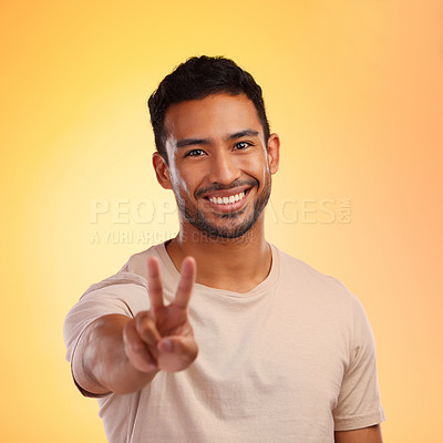 Buy stock photo Portrait, hands and man with peace sign in studio isolated on a yellow background. Face, fashion and hand gesture, v symbol or emoji of happy young male model in stylish, designer and cool clothing.