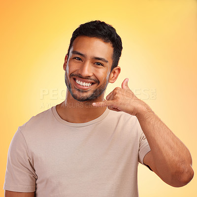 Buy stock photo Portrait, call me hands and man in studio isolated on a yellow background. Face, fashion and happy male model with cool hand gesture for shaka sign, symbol or emoji for communication and connection.