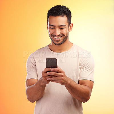 Buy stock photo Man, studio and phone for social media, chat and online dating with smile, reading and happiness. Model, smartphone communication and texting app on social network ui and digital contact on internet
