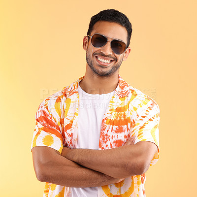 Buy stock photo Shot of a young man wearing glasses and a tie dye shirt while standing against a yellow background