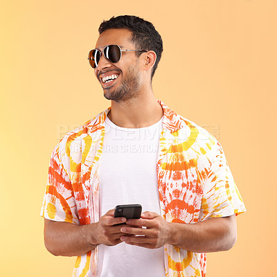 Buy stock photo Sunglasses, phone and man typing in studio isolated on a yellow background. Technology, thinking and happy male model with mobile smartphone for social media, text messaging or internet browsing.