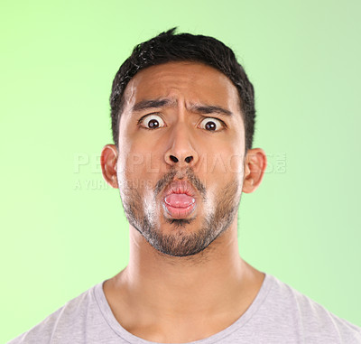 Buy stock photo Man, portrait and humor in studio, tongue and goofy comic or funny face on green background. Male person, mockup space and guy for joke or comedy, student and awkward for crazy character and quirky