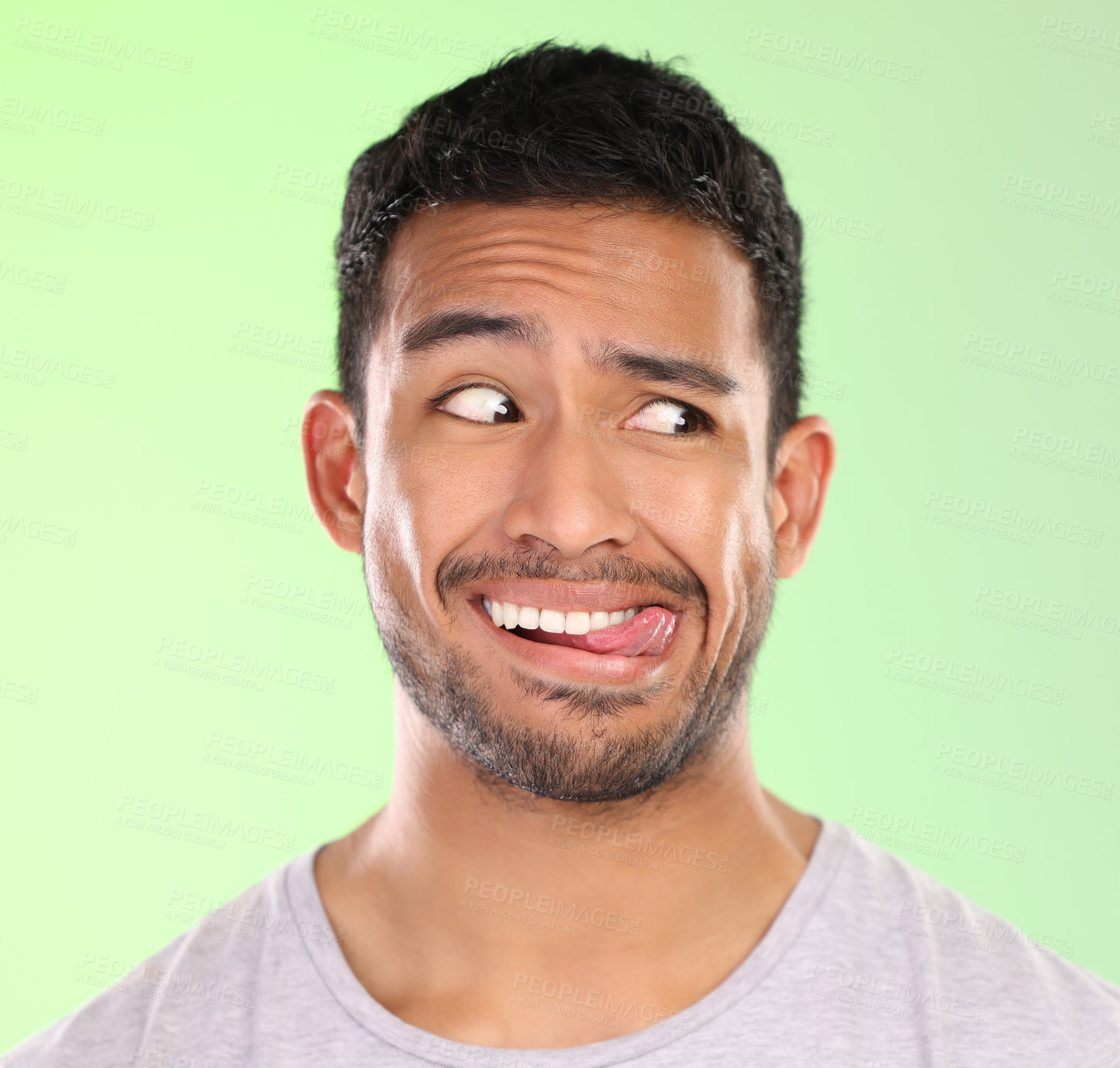 Buy stock photo Man, play and silly in studio, tongue and goofy comic or funny face on green background. Male person, mockup space and awkward for joke or comedy, student and humor for crazy character and quirky