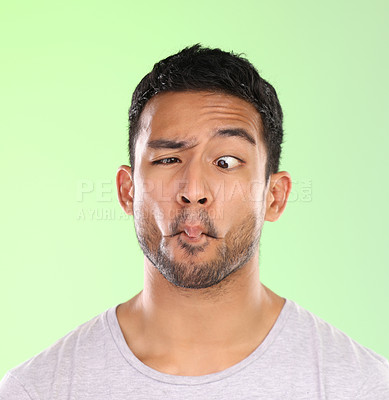 Buy stock photo Man, funny and comic face in studio with silly, goofy and emoji mouth with fun attitude for humor. Model, person and facial expression for comedy, joke and confidence with mockup on green background