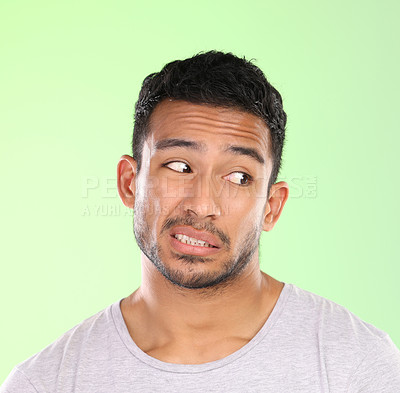 Buy stock photo Thinking, crazy and face of man with doubt in studio on pastel green background with awkward feedback. Confused, question and embarrassed person with puzzle, challenge or conflict in mock up space